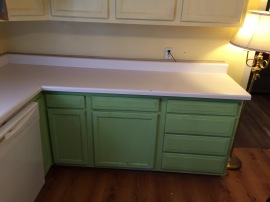 green cabinets, white counter